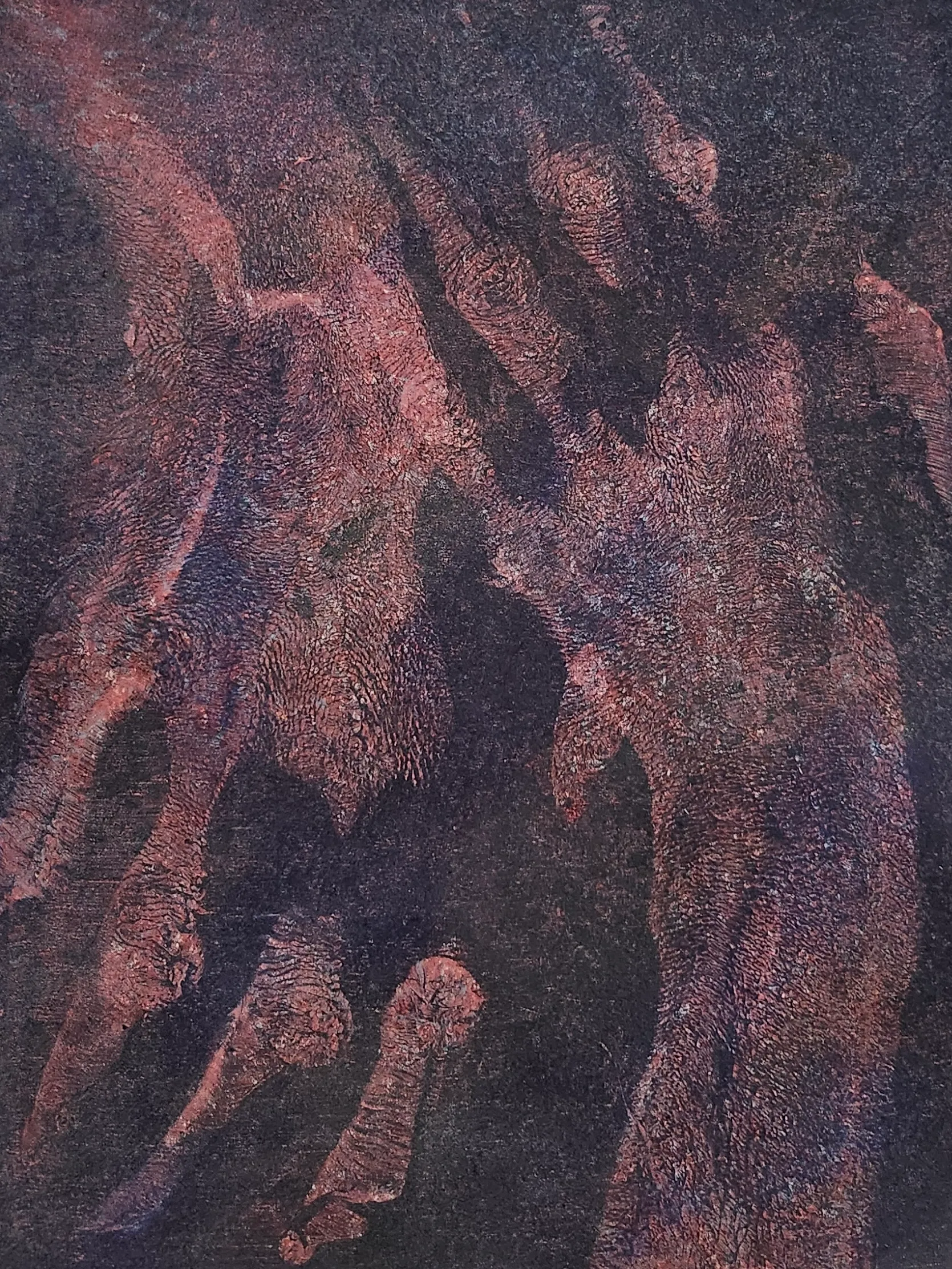 Warm reddish-brown handprints layered over one another against a dark ground, richly textured.